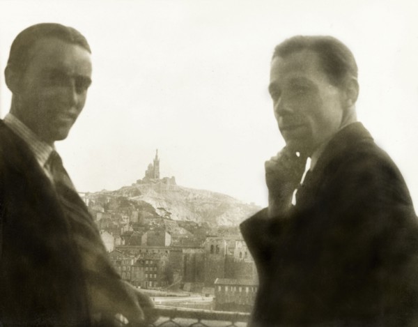 Visiting Marseille. Two British men pose whilst looking over the city of Marseille, where the