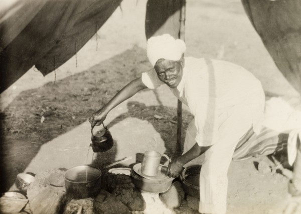 Methodist missionary camp site. A Methodist evangelist called Simon pours water from a kettle into