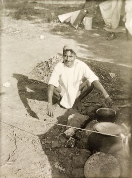 Cooking food at a Methodist camp site. A Methodist evangelist called Markappa cooks food over a