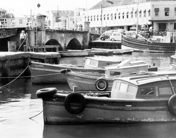 The Careenage in Bridgetown. A number of small motor boats are moored along the Careenage.