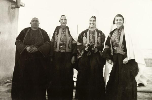 Women in traditional Palestinian attire. Group portrait of four women, dressed in traditional
