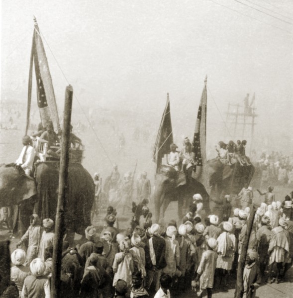 Procession at the Ardh Kumbh Mela. A procession containing elephants and banners passes through