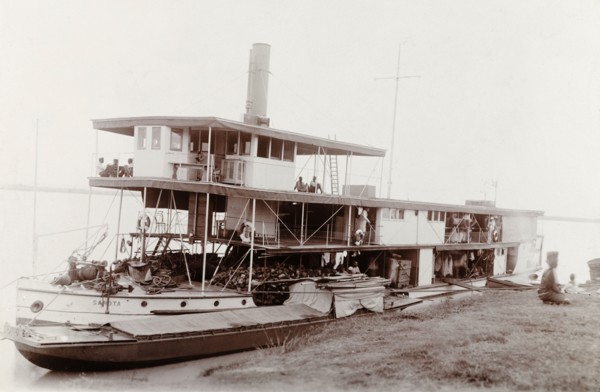 A paddle steamer named 'Sarota', Nigeria. A paddle steamer named 'Sarota' is moored to a riverbank