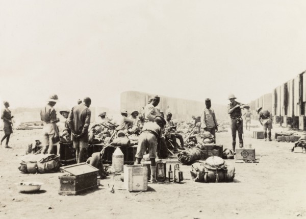 Schutztruppes unload supplies from a train. German and African schutztruppes organise their luggage