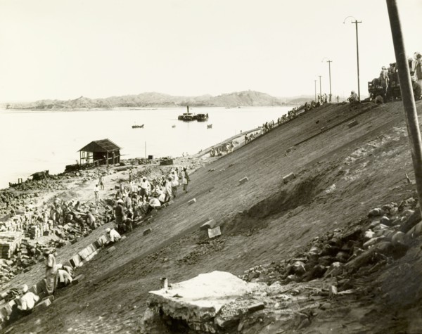 Constructing an embankment at Chauk. Labourers lay pitching bricks on a steep, clay-faced