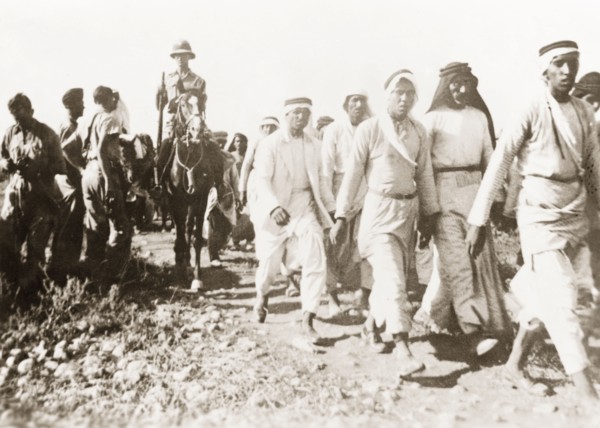 Marching Palestinian Arabs to a detention centre. British soldiers march a group of Palestinian
