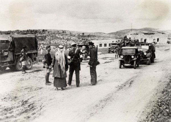 Patrolling a border checkpoint in Arabah. Armed British and Arab police officers patrol a border
