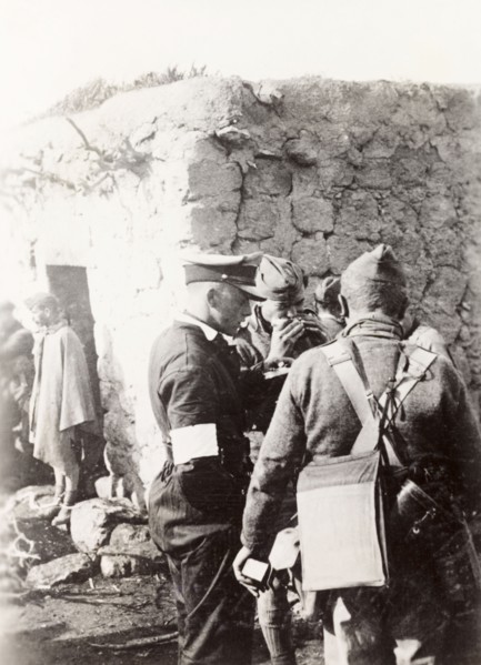 Police and army cooperation' in Samaria. British soldiers and police gather outside a village