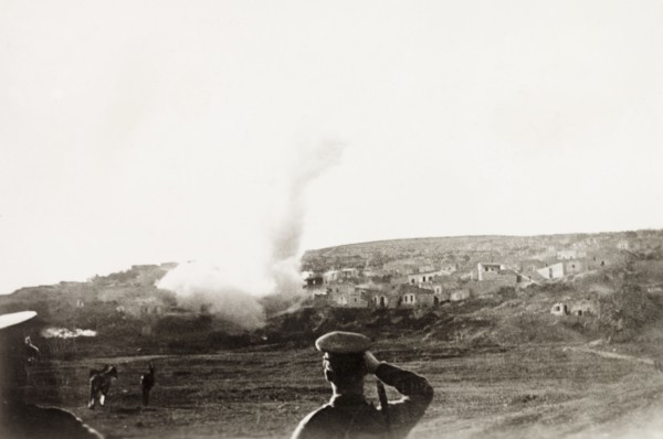 Mortar attack on a Palestinian village. British military officers look on as their mortar shell