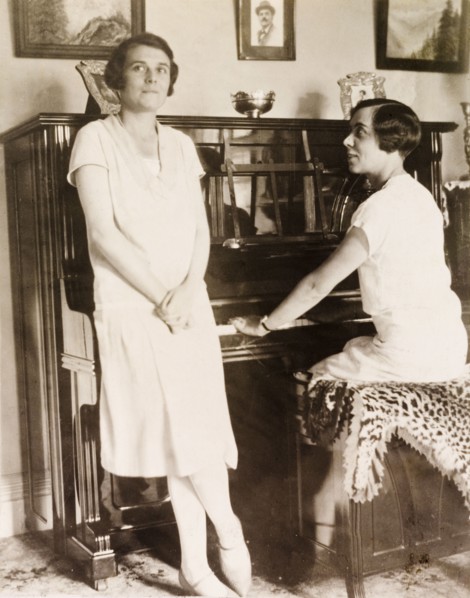 At the piano, Eastbourne. Portrait of two women at the piano in the drawing room of an English