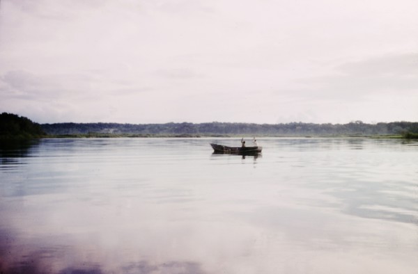 Fishing off Buvuma Island. Two early-morning fishermen man a small boat off Buvuma Island, on the