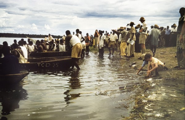 Regatta at Katunguru. Crowds line the banks of the Kazinga Channel to watch a canoe race at the