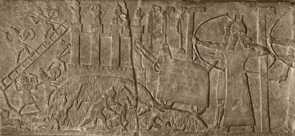 Stone relief from the Palace of Tiglath   Pileser attacking a city with a battering ram