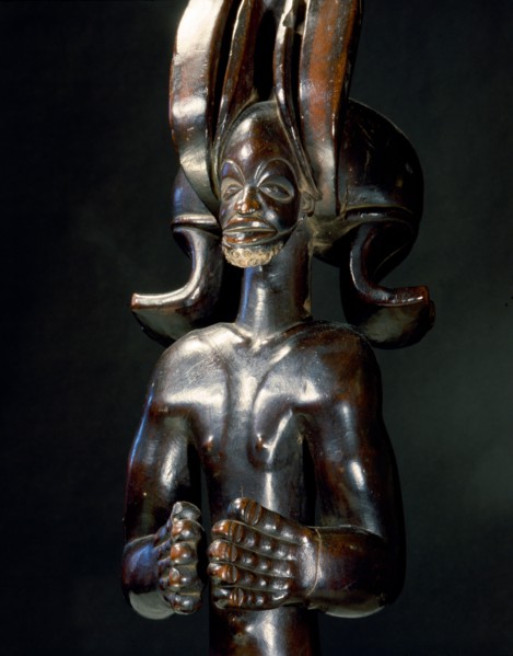 Wood figure of wearing headdress that is characteristic of Chokwe chiefs and also found on important masks