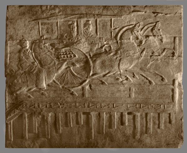 Brick from a tomb structure impressed with horses and carriage crossing a bridge