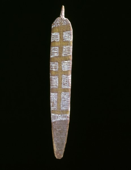 An incised wood hair ornament worn during sacred dances
