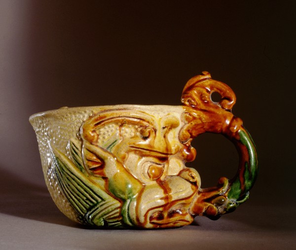 Rhyton cup with handle in the form of a lotus which emerges from the mouth of a symbolic monster mask or tao tieh