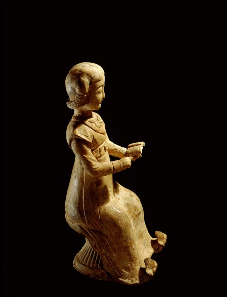 Figure of a seated woman reading a book
