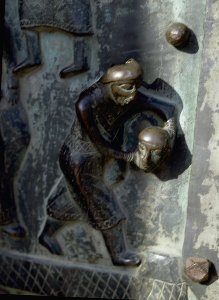 Detail of the bronze door of the Basilica of San Zeno which is decorated with 48 panels illustrating biblical stories and the lives of St Peter, St Paul, St Zeno, St Helena among others, and items con...