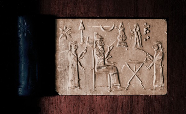 Depiction of seated king holding a drinking bowl and two attendants with fan and fly whisk