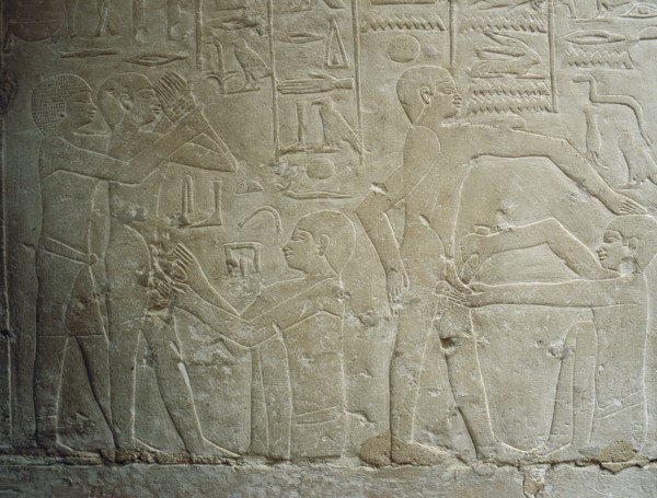 A detail of a relief in the tomb of Ankhmahor at Saqqara depicting a priest performing ritual circumcision on a young boy