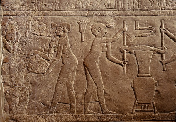 Bas relief from the tomb of Pairkep showing servant women squeezing oil from lilies in a press for use in perfume