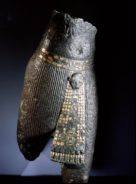 Bronze torso with belt and pleated garment decorated with copper and gold