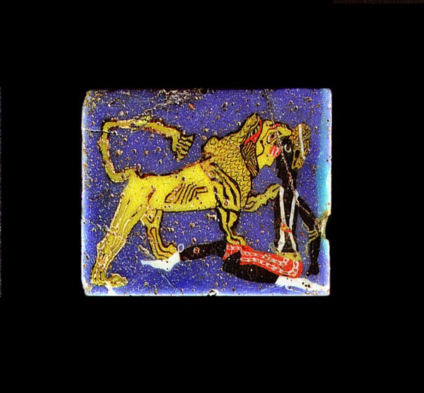 Glass plaque depicting a lion, representing the pharaoh, devouring a Nubian prisoner