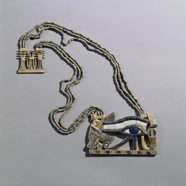 A pendant from the tomb of Tutankhamun in the form of a Wedjat eye, symbol of protection, flanked by the vulture goddess, Nekhbet and the snake goddess Wadjet, protectors of Upper & Lower Egypt