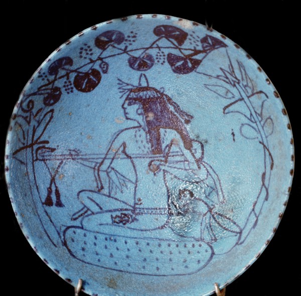 A faience dish decorated with a design of blossoms and a girl playing the lute