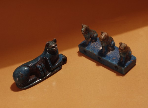 Amuletic spacer bead in the form of three sitting cats and an amulet in the form of a reclining cat with two suckling kittens