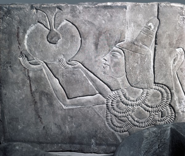 A fragment of a relief, depicting a courtier offering a necklace from a window of appearance