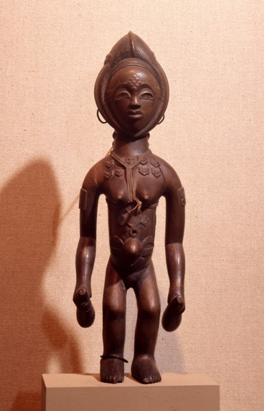 A wood figure of a young woman with decorative scarifications, holding two gourd containers