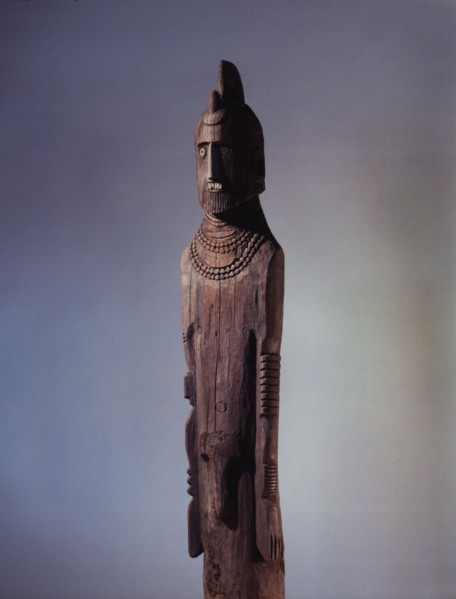 Wooden memorial statue used as a grave marker
