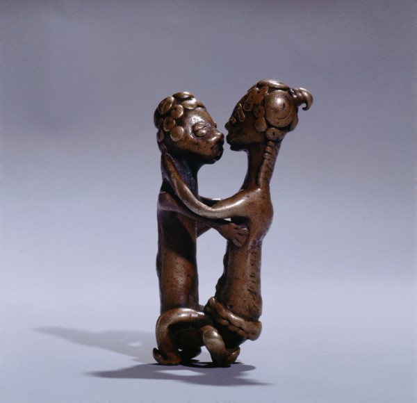 A gold weight representing a man and woman during sexual intercourse