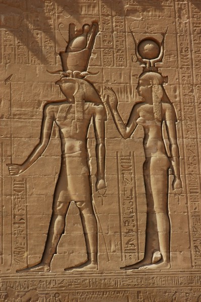 Reliefs on the outer back walls of the temple complex depicting a pharaoh and the goddess Isis