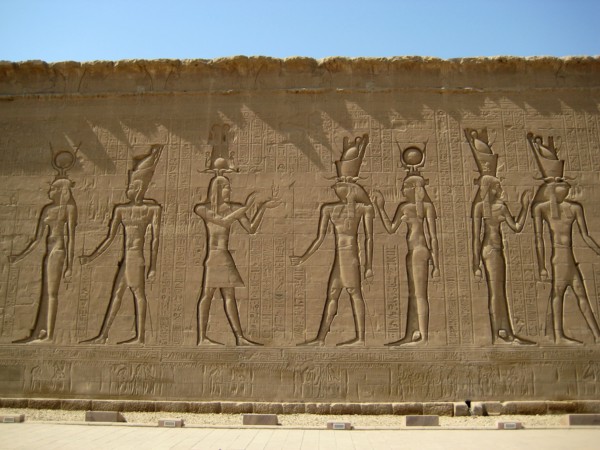 Reliefs on the outer back walls of the temple complex depicting a procession of gods and goddesses including Horus (with the falcon head) and Isis