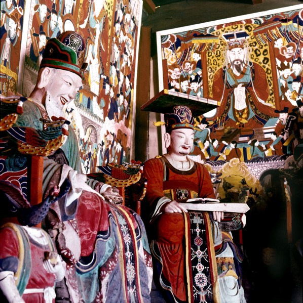 Thankas and statues of Taoist sages or monks inside the temple on Diamond Mountain