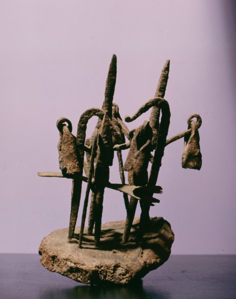 A sculpture from an ancestral shrine incorporating representations of spears and bells
