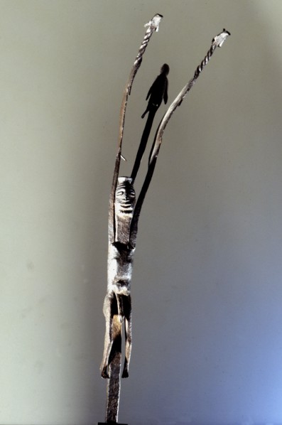 An altar iron in the form of a stylized figure with upraised arms