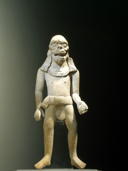 Standing ball player wearing a skull headdress
