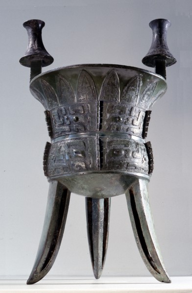 Archaic bronze vessel (jia) decorated with decoration of three large taotie masks against a ground of leiwen and stylized cicada patterns