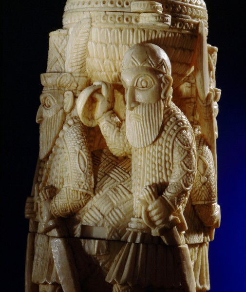 An ivory salt cellar around the base of which are figures of Portuguese noblemen