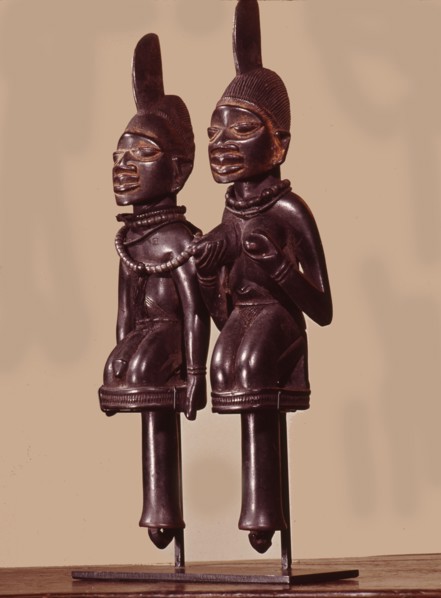 Dance staffs depicting male and female devotees of Eshu, identifiable by the projection from their heads