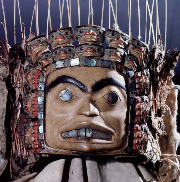 Chiefs headdress with humanoid face surrounded by a row of abalone shell and a double row of smaller faces
