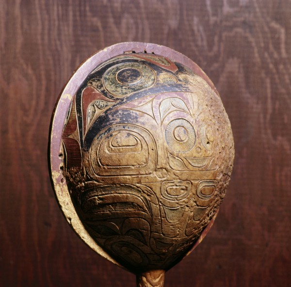 Shamans rattle painted and carved in low relief
