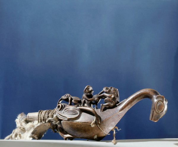 Shamans rattle in the form of a bird or sea monster with a shaman torturing a witch on its back