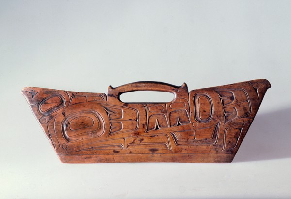 Bark shredder made of wood and carved in relief