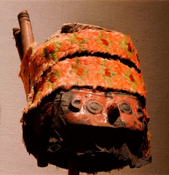 This elaborate death mask, originally attached to a Chimu mummy bundle, has a copper face mask painted red