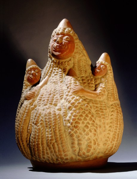 Mochica effigy jar depicting three anthropomorphised maize cobs whose fanged mouths and staring eyes suggest they are gods associated with fertility and food